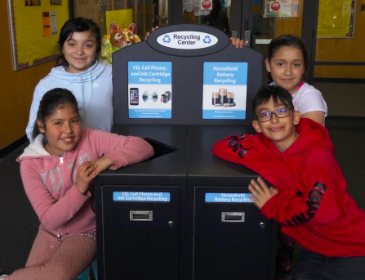 Evergreens Club members at the new recycling center for phones, CDs, and batteries